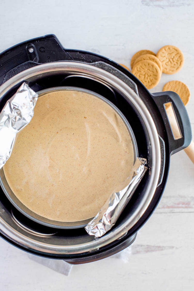 placing a cheesecake in a pressure cooker