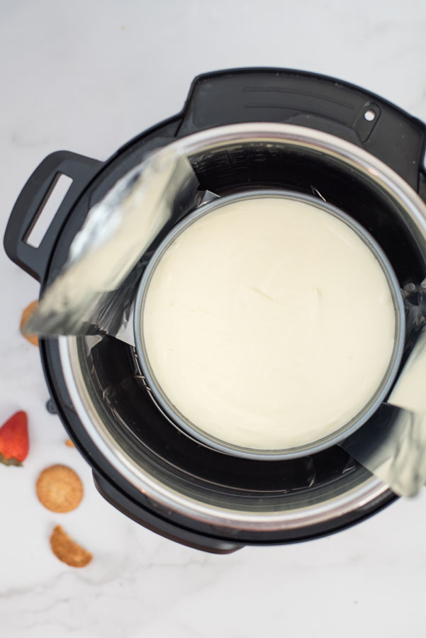 Overhead shot of cooked cheesecake inside an Instant Pot electric pressure cooker