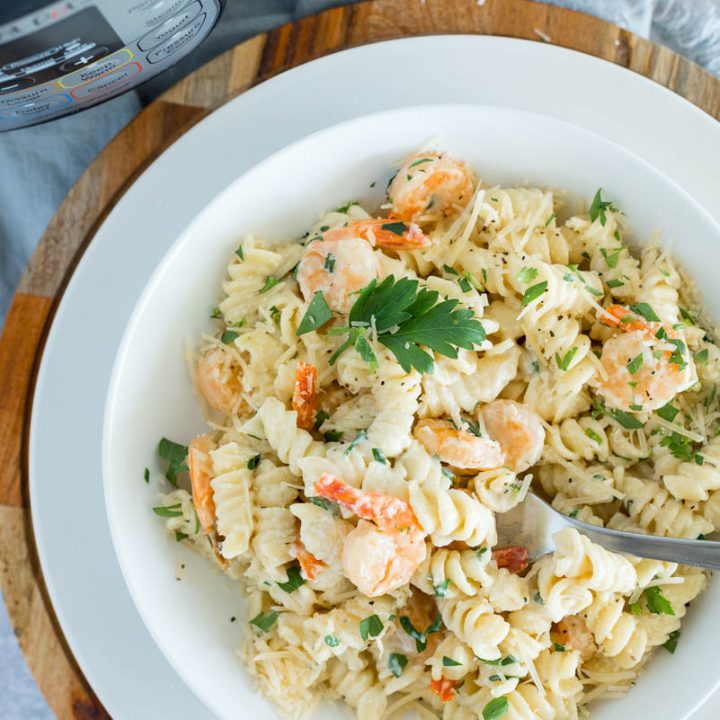 white bowl of instant pot shrimp alfredo rotini pasta