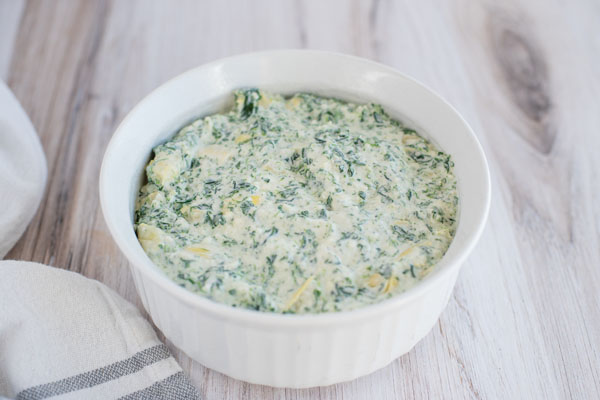 Hot Instant Pot spinach artichoke dip served in a ramekin.