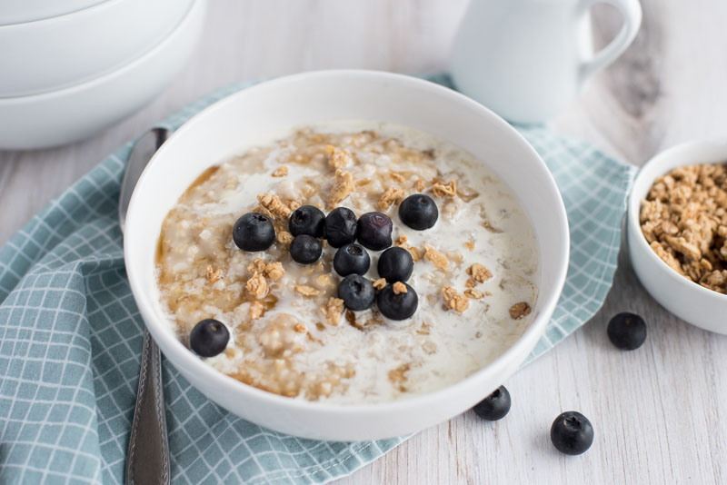 pressure cooker oatmeal with blueberries in a white cereal bowl