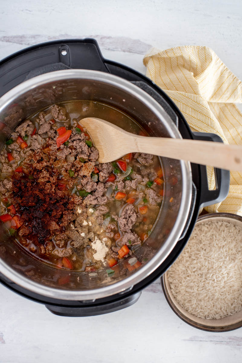 overhead of an instant pot cooking vegetables and meat for rice