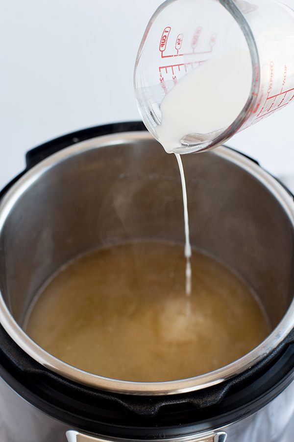 Adding corn starch slurry to thicken Instant Pot turkey gravy.