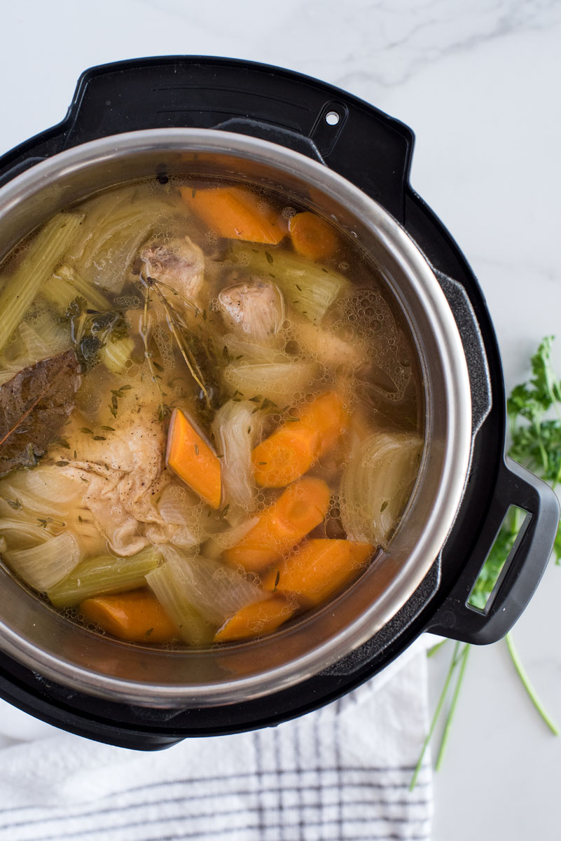 Overhead shot of turkey stock cooked in an Instant Pot that is ready to be strained.