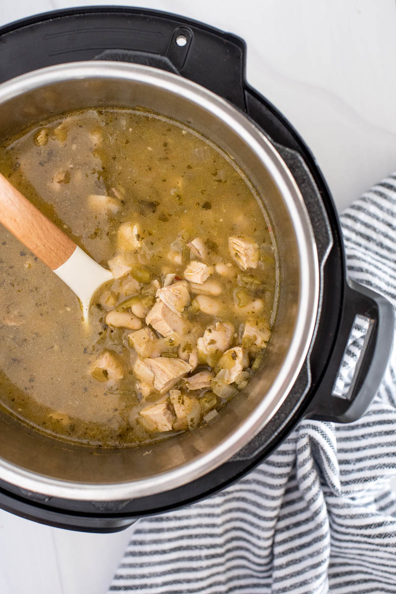 overhead of an electric pressure cooke with white chicken chili and beans