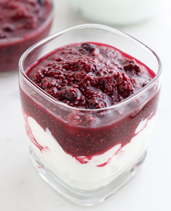 45 degree shot included in the Instantly Sweet Dessert Cookbook - featuring a square glass filled with Honey Vanilla Greek Yogurt on the bottom and Berry Cherry Chia Compote on top