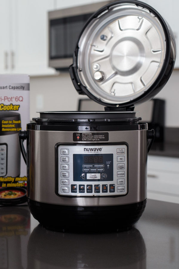 Nutri Pot NuWave Pressure Cooker with lid opened on a hinge.