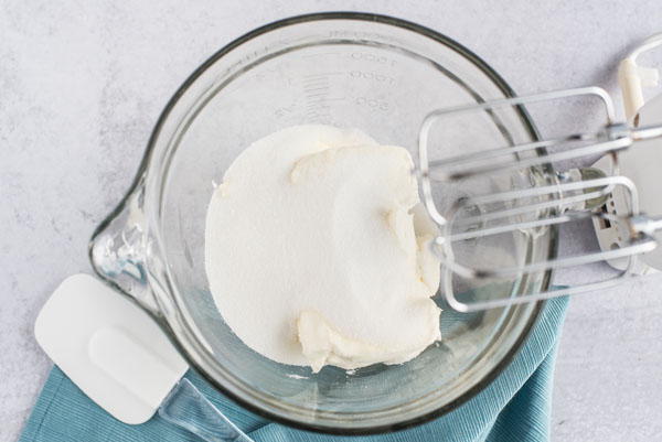 mixing cream cheese and sugar for cheesecake until combined.