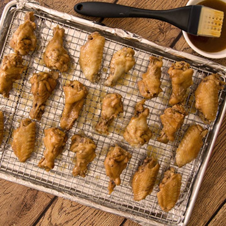 Shortcut Instant Pot wings  on a cooking rack ready to baste with sauce and go into the oven to broil