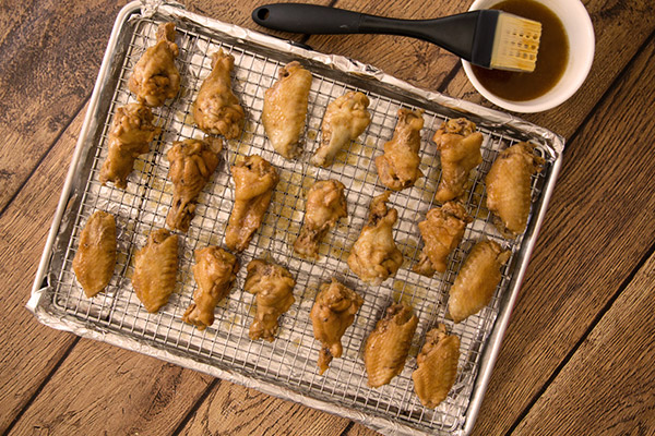 Shortcut Instant Pot wings  on a cooking rack ready to baste with sauce and go into the oven to broil