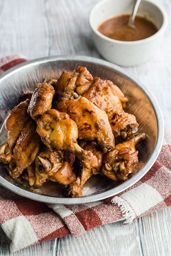 Instant Pot chicken wings served in a tin with a dipping sauce side.