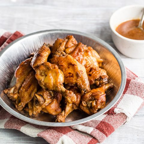 Instant Pot / pressure cooker teriyaki chicken wings placed in a tin and ready to serve.