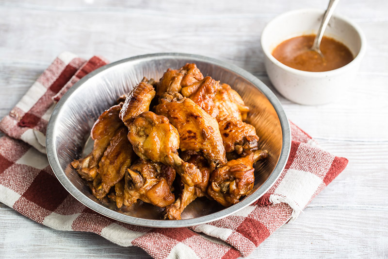 Instant Pot / pressure cooker teriyaki chicken wings placed in a tin and ready to serve.