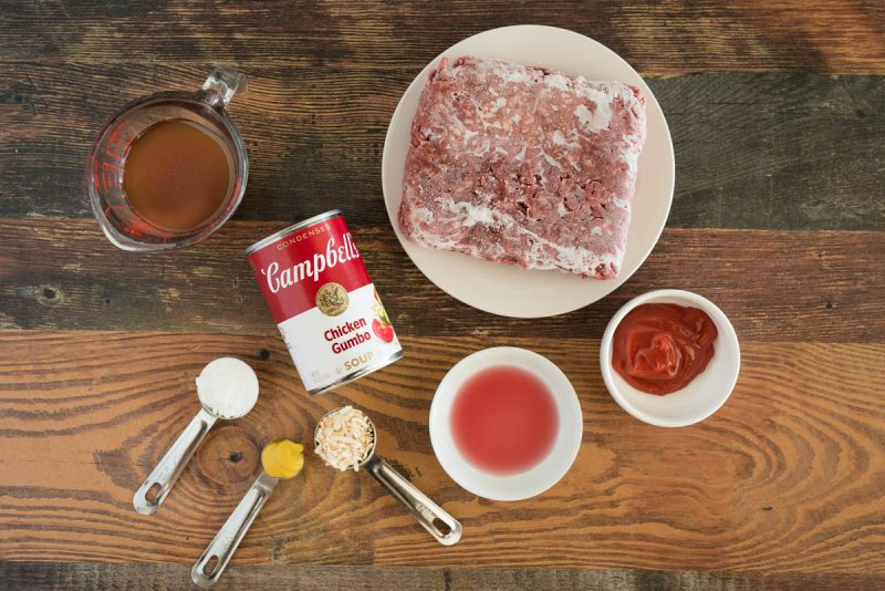 Ingredients for Instant Pot sloppy joes with frozen beef, chicken gumbo soup, ketchup, beef broth, red wine vinegar, dehydrated onions, mustard, and corn starch.
