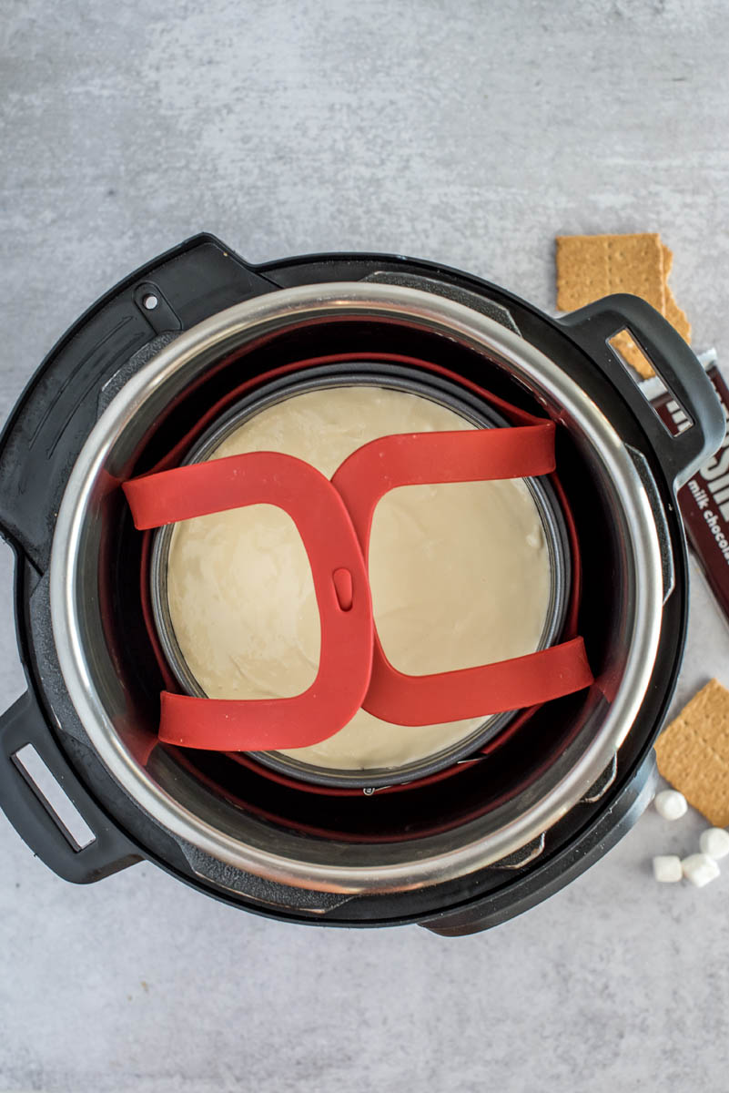 Overhead picture of a cheesecake placed in an Instant Pot and ready to cook.