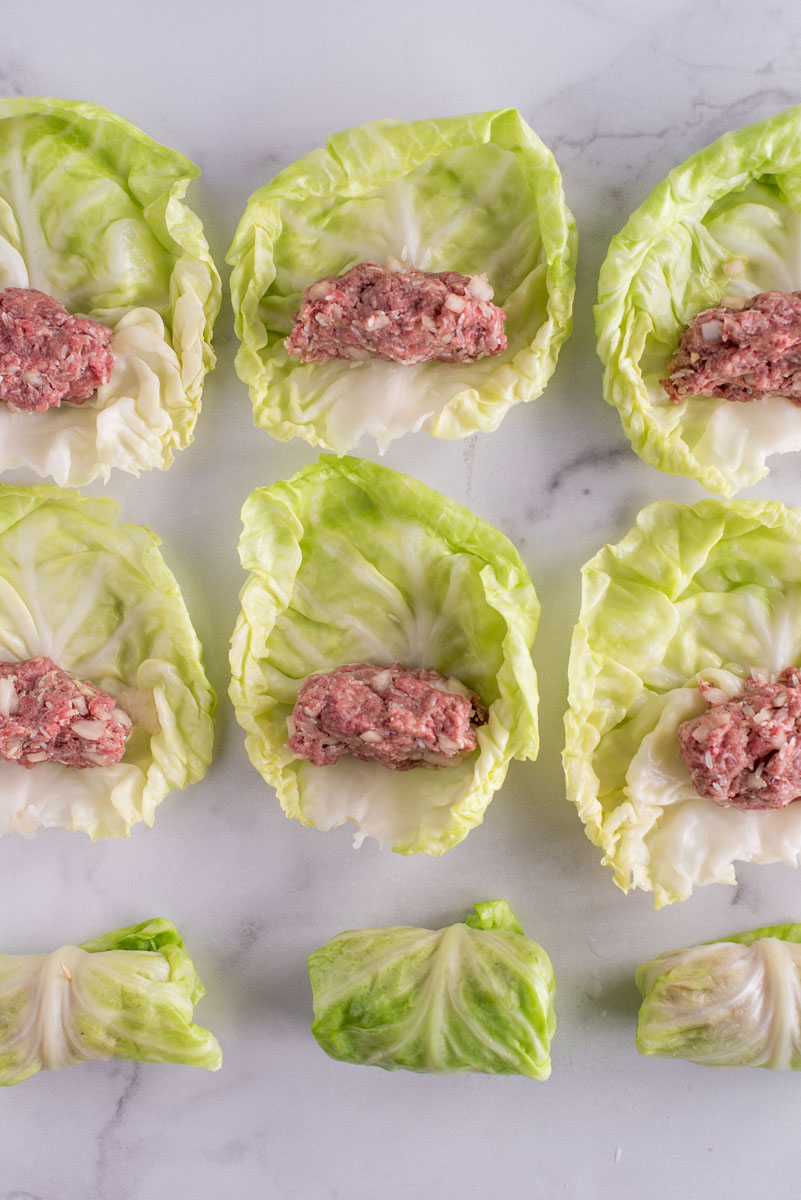 overhead of cabbage leaves stuffed with meat filling