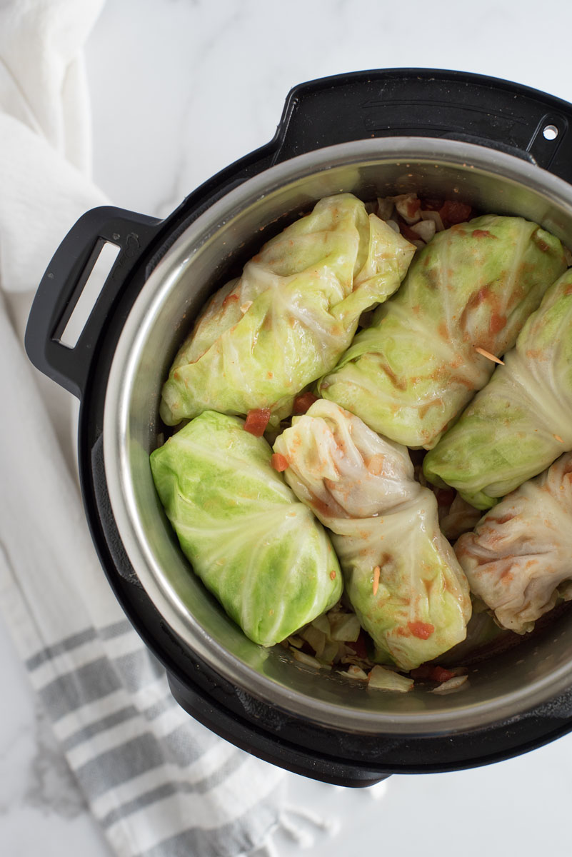 overhead of an instant pot with uncooked cabbage rolls