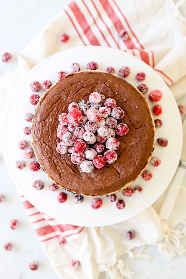 Top view, looking down on a Pressure Cooker Triple Chocolate Layered Cheesecake garnished with sugared cranberries