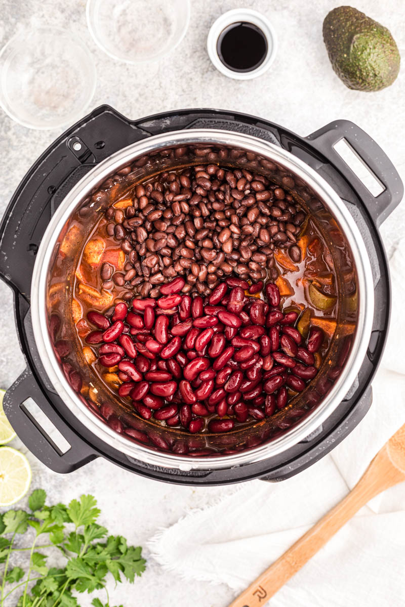 An overhead shot into an Instant Pot, adding the two different beans