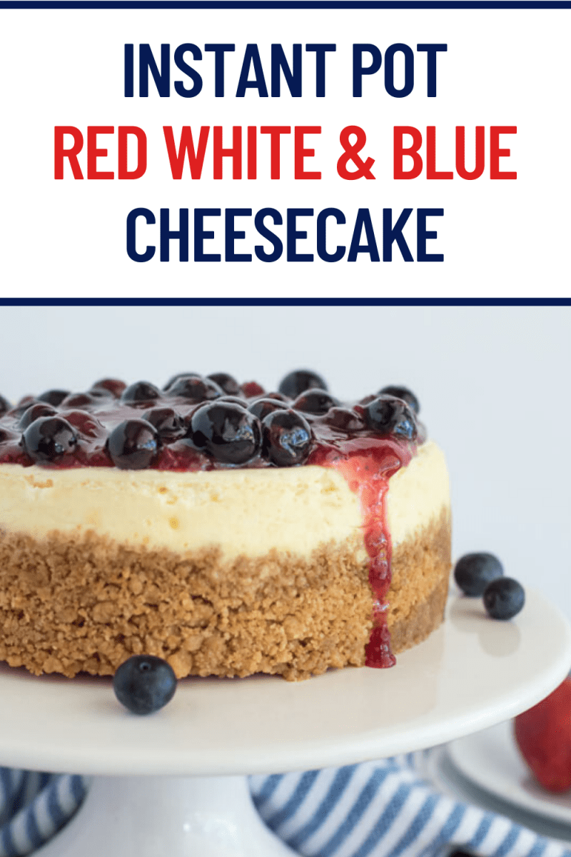 titled photo: Red White & Blue Cheesecake - cheesecake on a white cake plate, topped with blueberry and strawberry compote